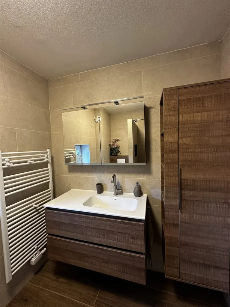 Badkamermeubel met radiator en spiegel (Badkamer met houtlook tegels)