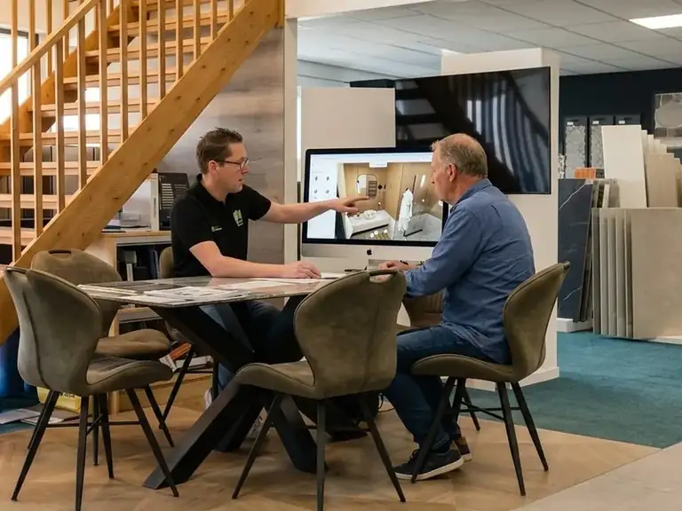 Adviseur en klant ontwerpen samen een badkamer in 3D in de showroom van MIJS Tegels & Sanitair in Zwaag